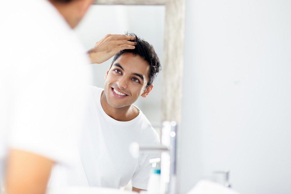 Guy in Mirror | Hair Restoration | Absoultue Vitality
