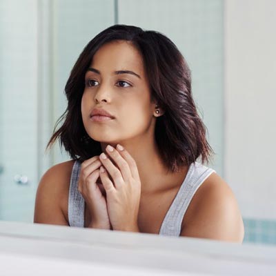staring in mirror | Laser Acne Treatment | Absoultue Vitality
