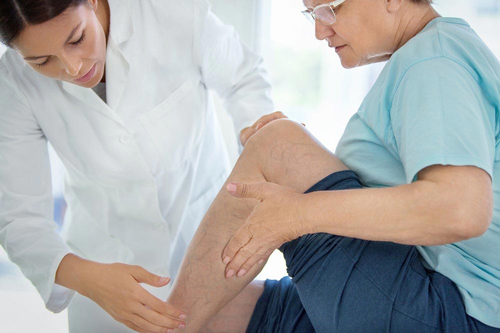 Doctor checking patients leg
